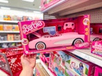 hand grabbing a hot wheels barbie rc corvette off a target shelf