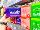 hand holding the blueberry pomegranate 8-pack of Bubly next to other flavors