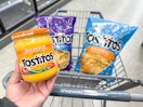 hand holding tostitos dip and chips in walgreens cart