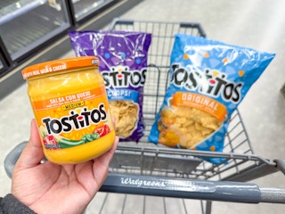 hand holding tostitos dip and chips in walgreens cart