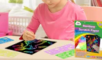 a kid drawing on rainbow scratch paper