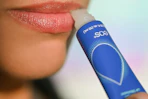 a woman applying eos lip repair