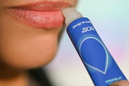 a woman applying eos lip repair