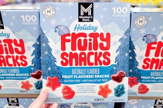 hand holding a box of members mark holiday fruit snacks