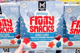 hand holding a box of members mark holiday fruit snacks