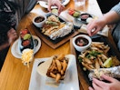 A table at Chili's covered in plates of food.