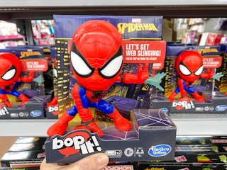 hand holding spider-man bop it game at walmart