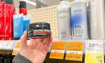 person holding a hair gel by clearance shampoos