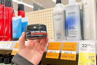 person holding a hair gel by clearance shampoos