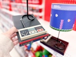 hand holding a nintendo super nes console table lamp at target