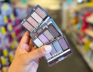 hand holding four Covergirl eyeshadows
