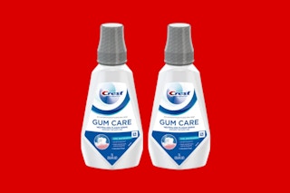 crest gum care mouthwash on a red background