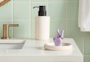 ceramic ring dish sitting on a bathroom countertop