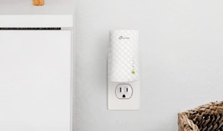 A WiFi extender plugged in to an outlet.