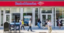 People walking outside of a Bank of America