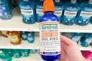 Person holding TheraBreath Mouthwash in store