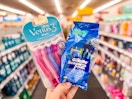 hand holding Gilette Sensor 2 and Venus 3 razors
