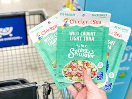 hand holding chicken of the sea tuna pouches