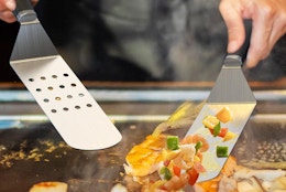 griddle spatulas turning food on a Blackstone 