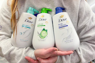 person holding three Dove pump body washes