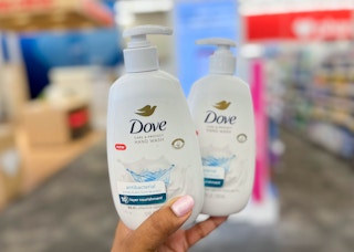 hand holding two dove hand soaps