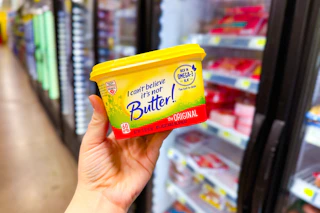 hand holding a tub of i can't believe it's not butter at dollar general
