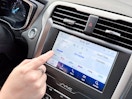 A person navigates a Sirius XM radio system