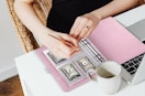 a person putting money in a binder