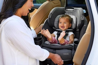 a mom taking her baby out of the Graco Turn2Me 3-in-1 Car Seat