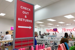 customers in line near tj maxx check out and returns signage