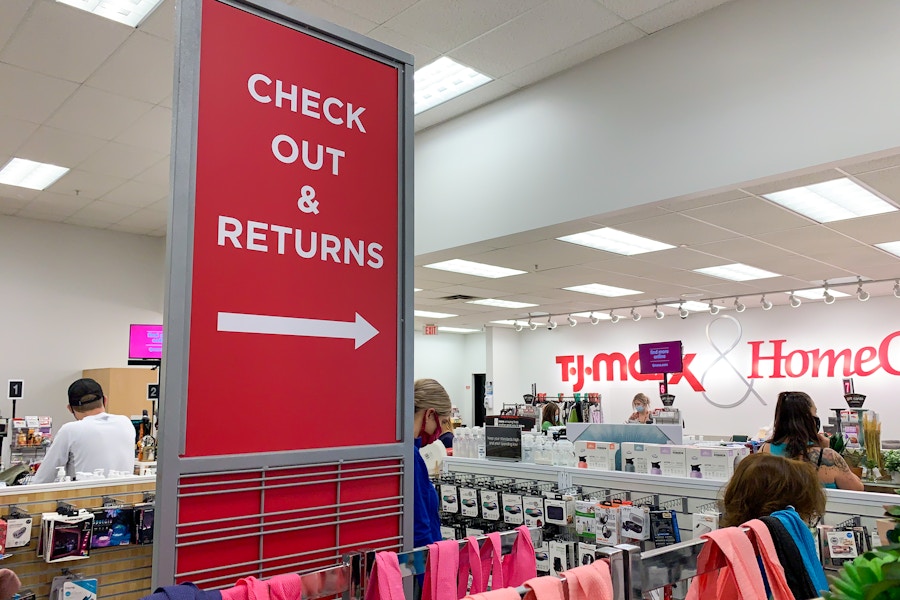 customers in line near tj maxx check out and returns signage
