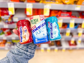 hand holding mentos gum varieties in walgreens