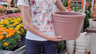 hands holding southern patio terra cotta planter at home depot