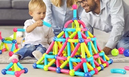 a kids playing with magnetic blocks