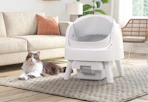 white automatic cat litter box with a cat next to it