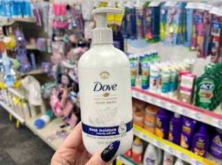 hand holding dove hand wash in aisle