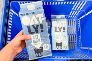 Oatly milk held over Walmart shopping basket with another carton inside