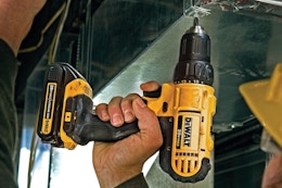 Man using the DEWALT 20V Max Cordless Drill/Driver Kit, 2 Batteries and Charger Included (DCD771C2).