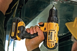 Man using the DEWALT 20V Max Cordless Drill/Driver Kit, 2 Batteries and Charger Included (DCD771C2).