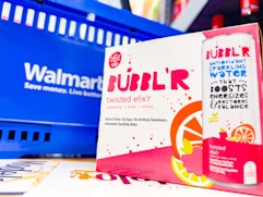 Bubbl'r Sparkling Water 6-Pack next to Walmart shopping basket