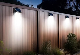 solar lights hanging on a privacy fence