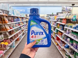 hand holding purex detergent in walgreens