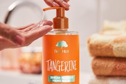 a woman using tree hut tangerine soap