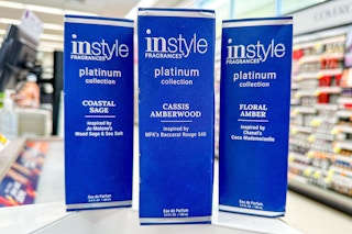 three instyle platinum collection fragrances on a store countertop