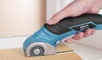 a person using an electric cardboard cutter on cardboard