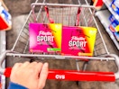 hand pushing a cvs shopping cart with playtex tampons