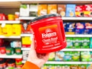 hand holding a folgers coffee canister at target