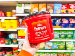 hand holding a folgers coffee canister at target