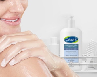 a person next to a bottle of body wash