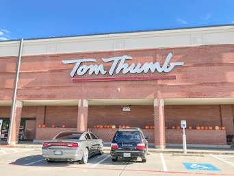 Tom Thumb grocery store, store front with cars parked in front.